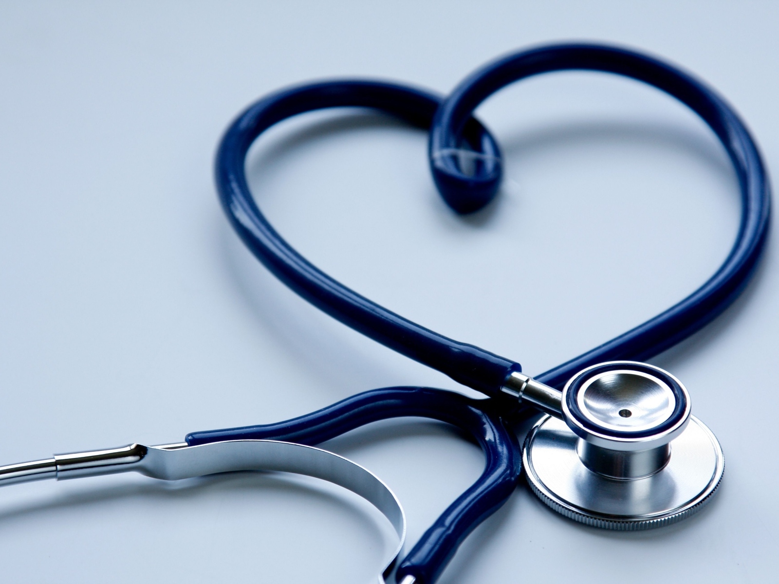 Сердце из стетоскопа на сером фоне