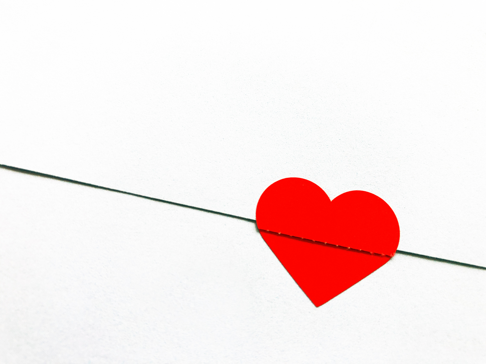 Красное сердечко на белом фоне из бумаги