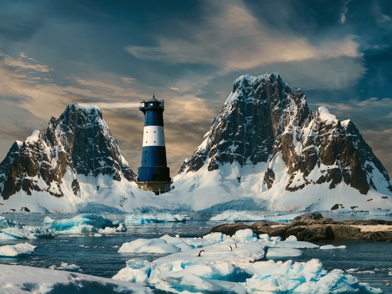 Large ice floes in the water near a lighthouse in the mountains, Antarctica