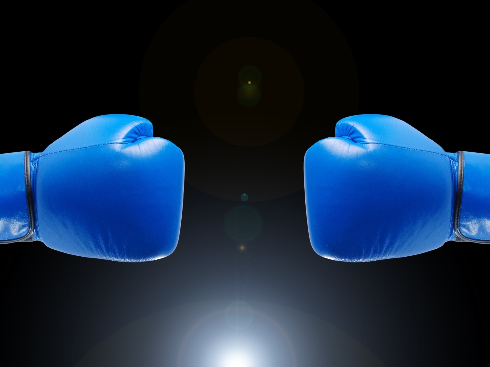 Синие боксерские перчатки на черном фоне
