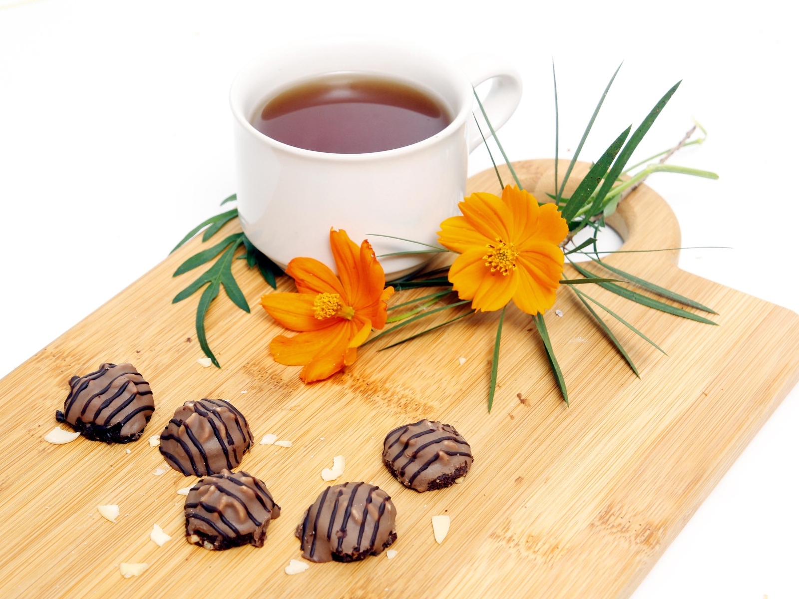 Чашка чая на деревянной доске с конфетами