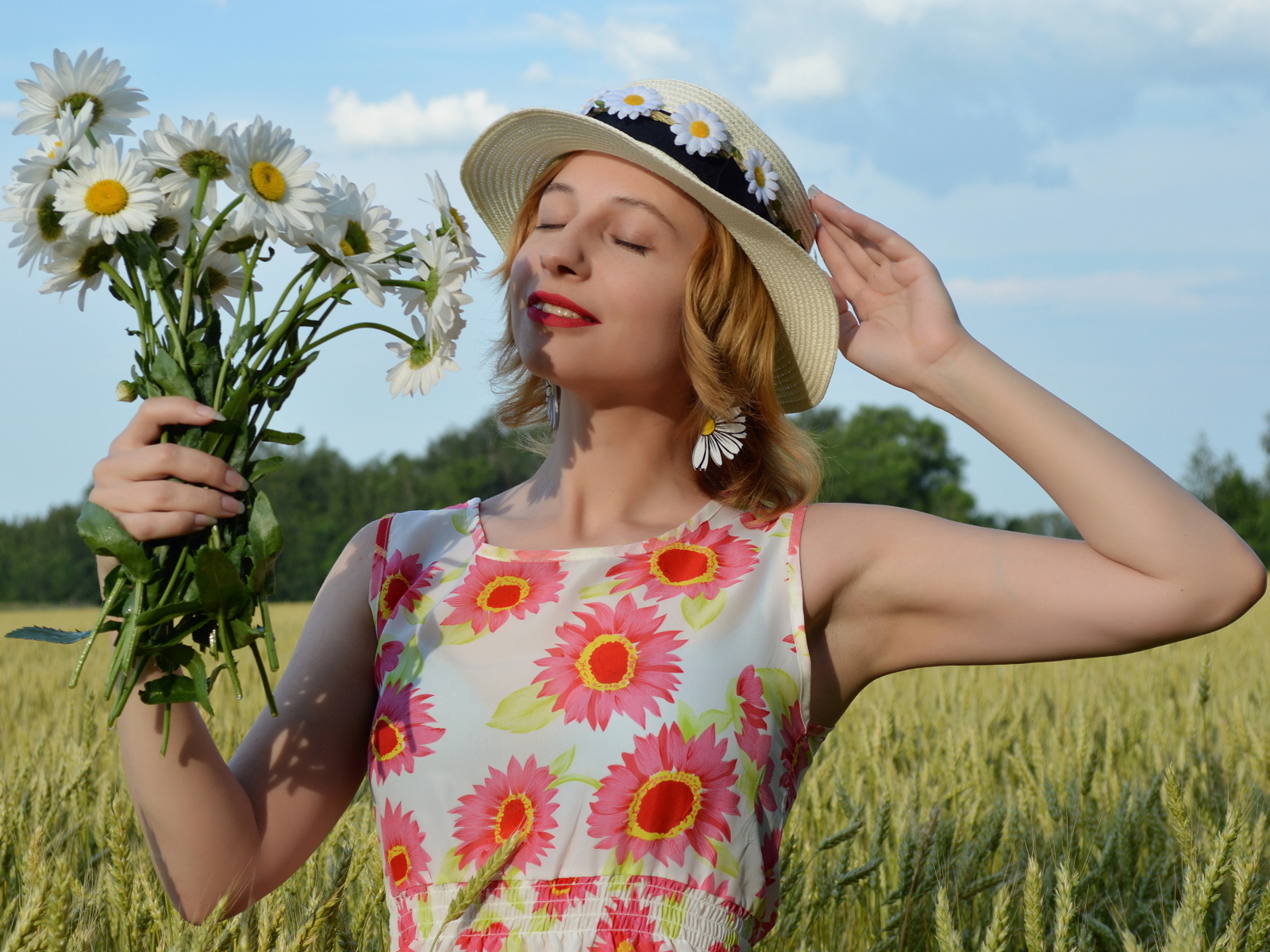 Девушка с букетом ромашек на поле