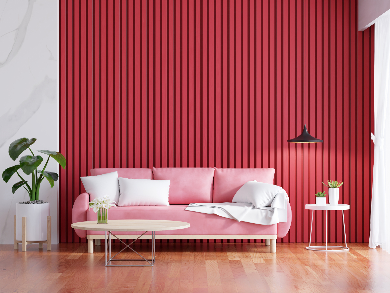 Розовый диван на фоне красной стены