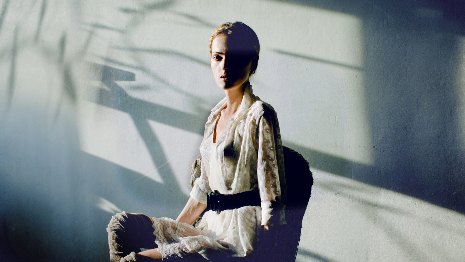 Фотография девушки на фоне белой стены