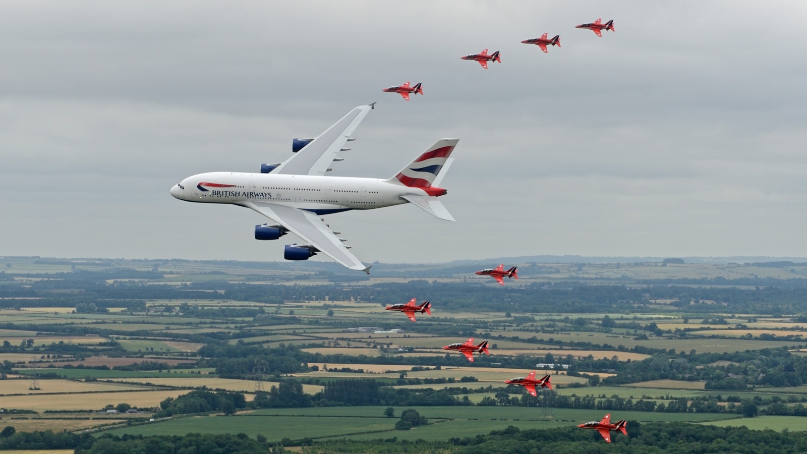 Airbus A380 в сопровождении красных истребителей