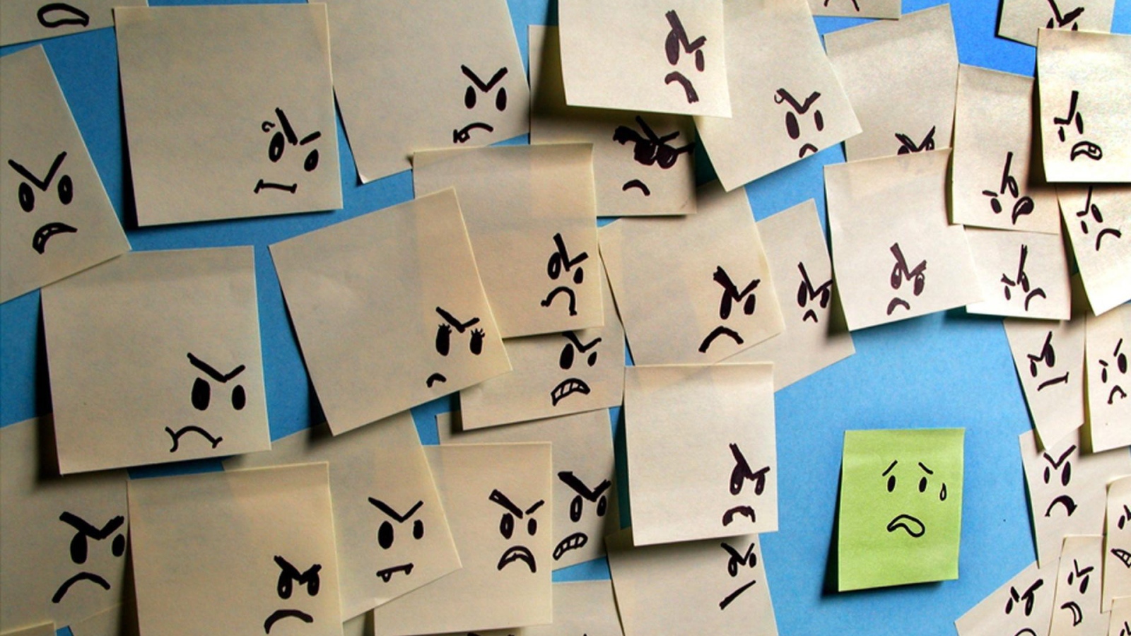 Испуганный стикер в окружении злых стикеров