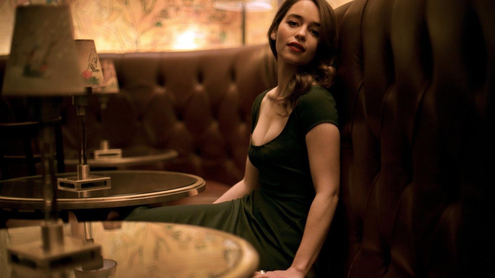 The girl in a green dress sitting on the couch