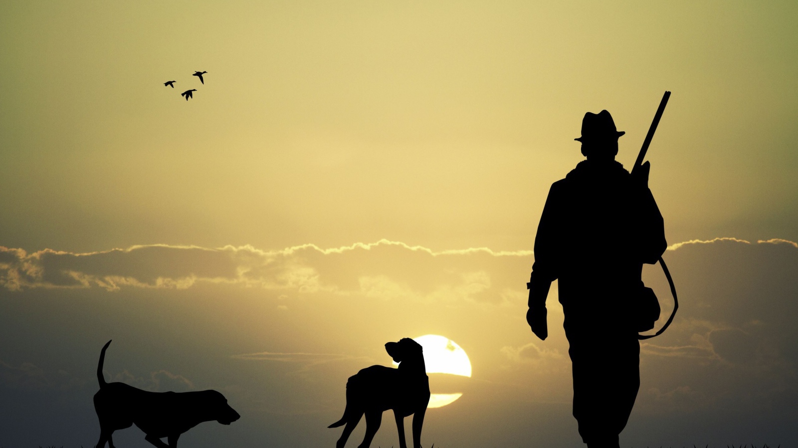 Охотник с собаками на фоне солнца