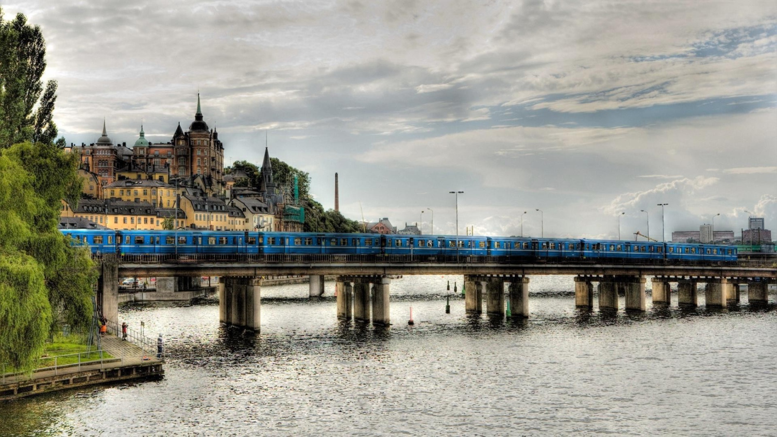The train crosses the bridge over the river in Sweden