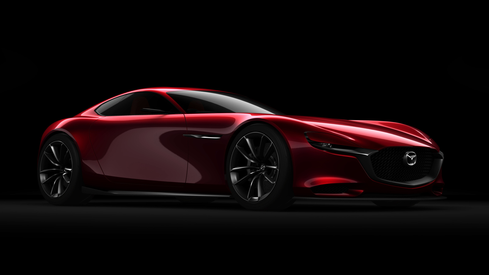 Красный спортивный автомобиль Mazda RX Vision Concept на черном фоне