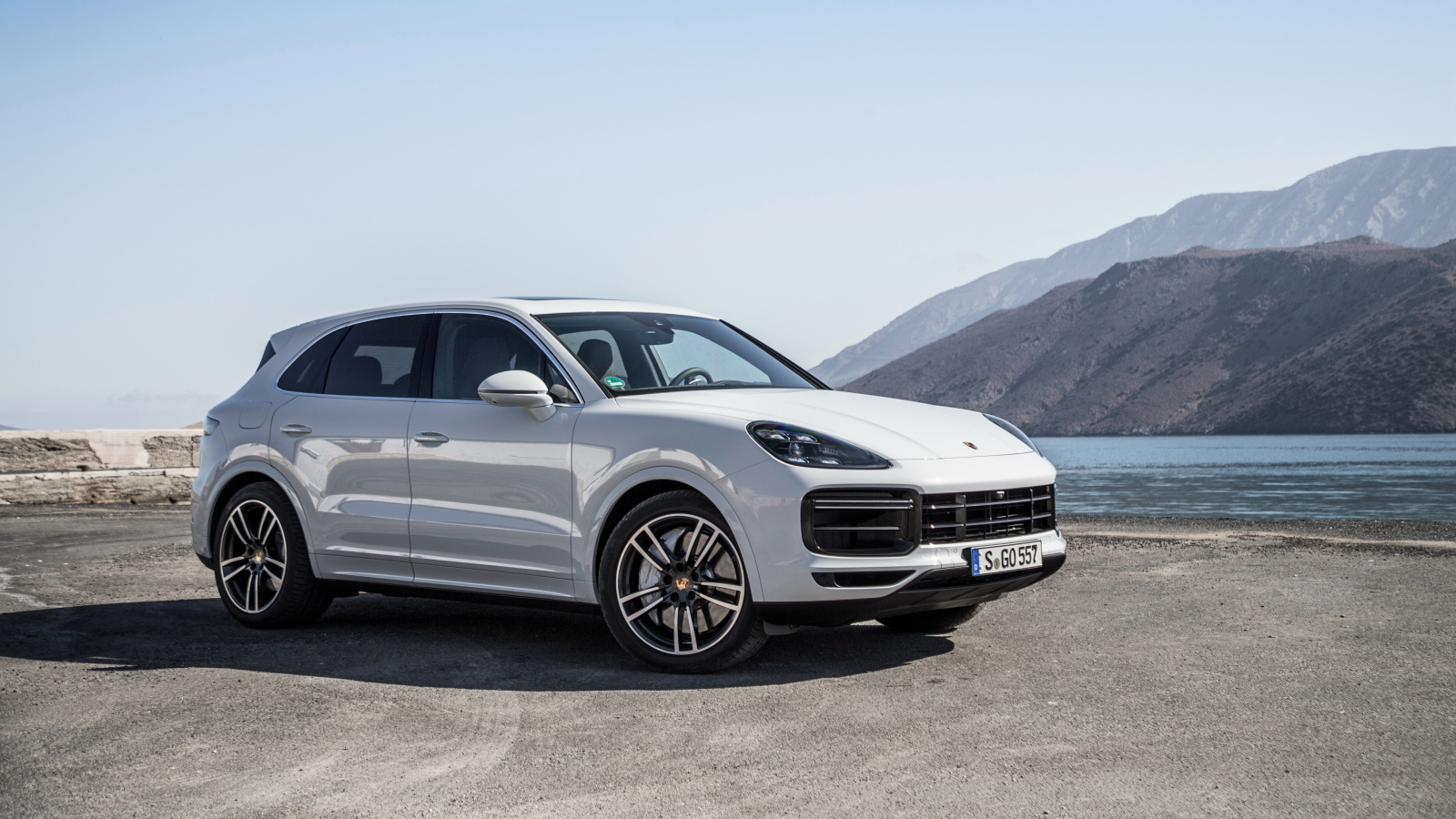 Белый автомобиль Porsche Cayenne Turbo, 2018 у воды