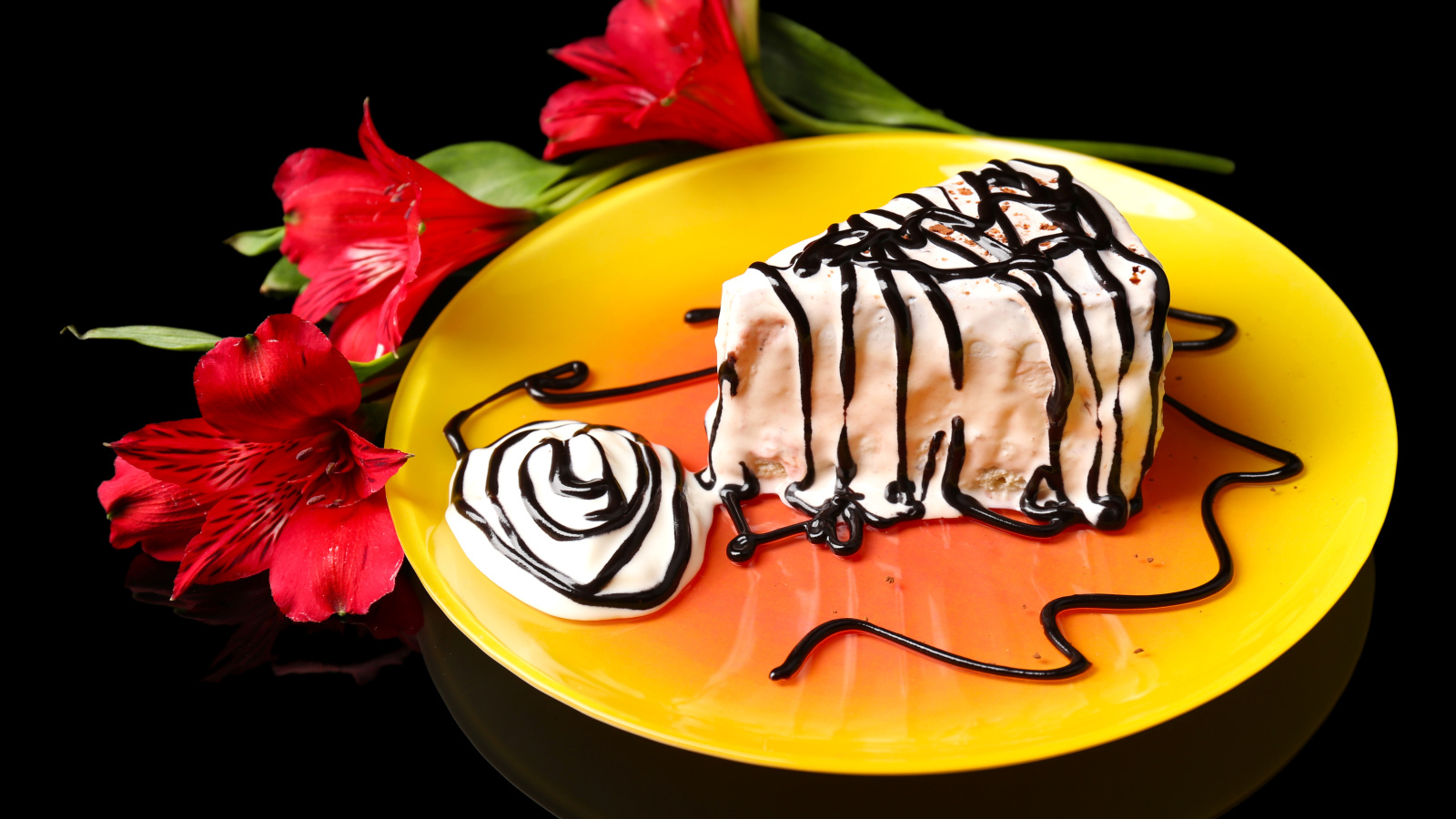 Аппетитное пирожное с шоколадом и цветком альстремерия на черном фоне