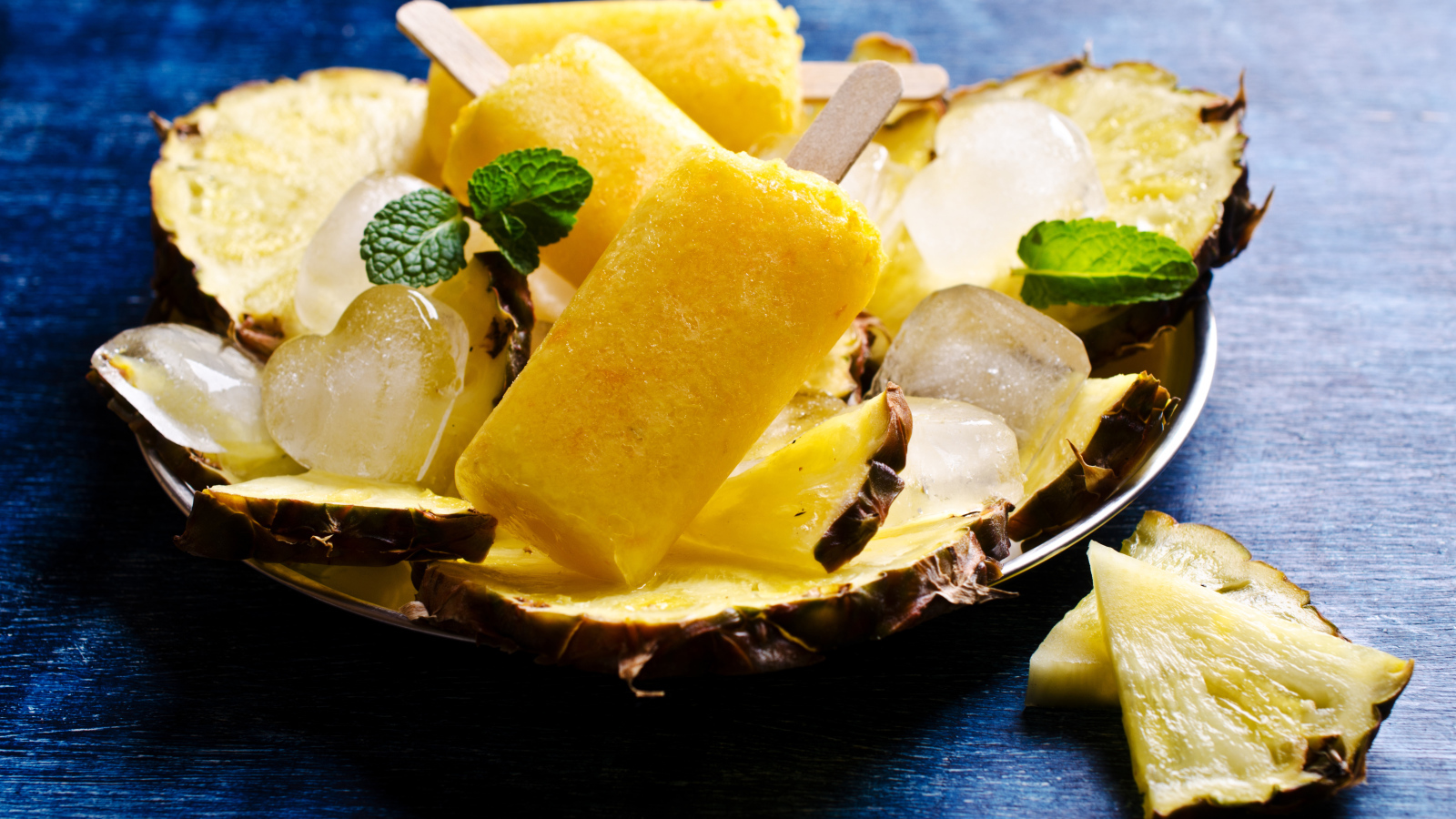 Ананасовое мороженое со льдом лежит на кусочках свежего ананаса