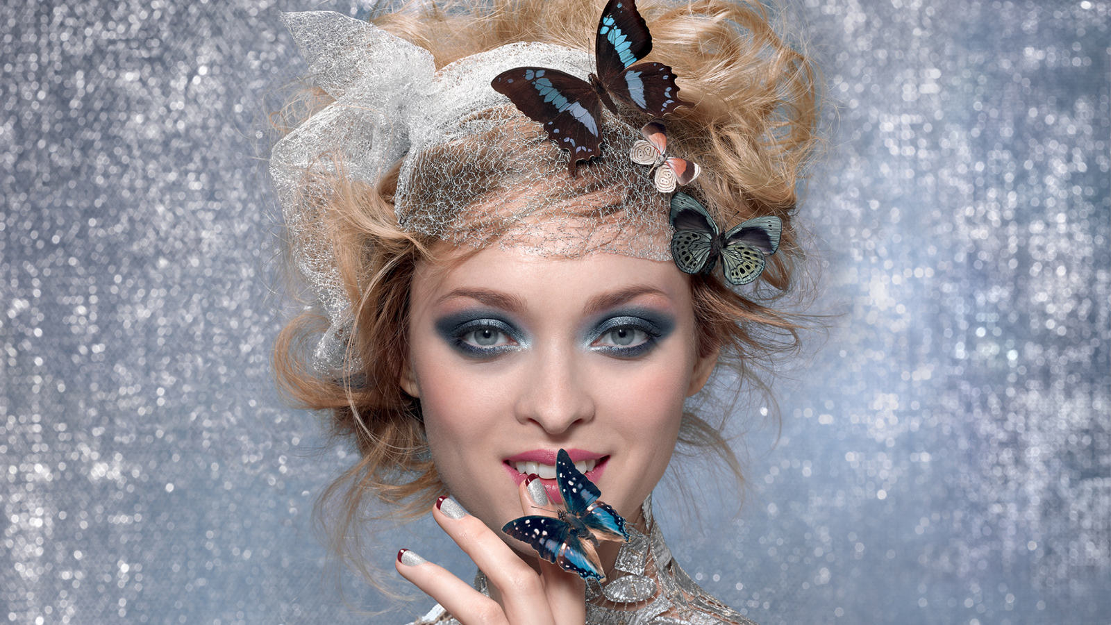 Красивая девушка с ярким макияжем и с бабочками в прическе