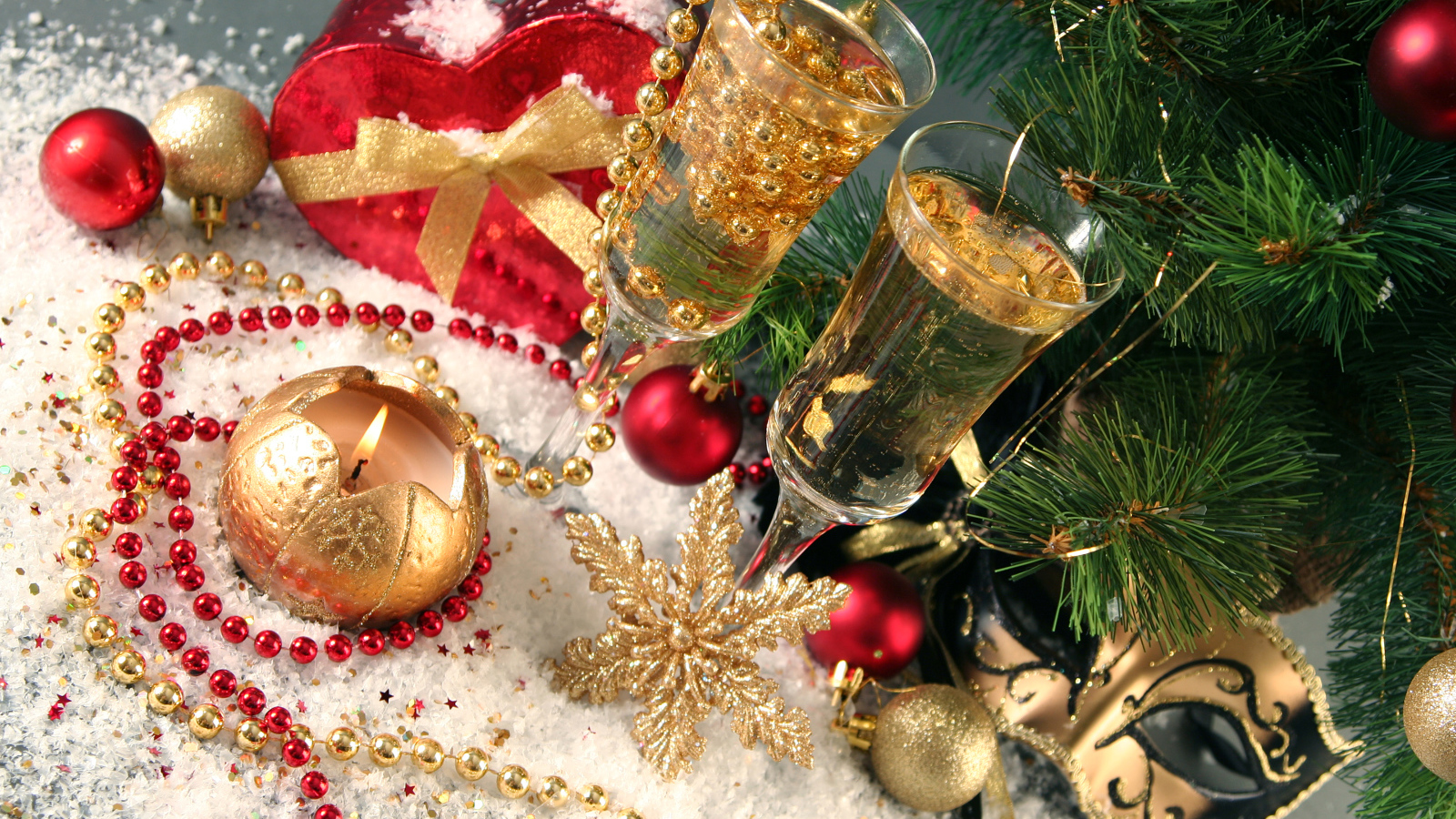 Two wine glasses with champagne with New Year decor under the Christmas tree