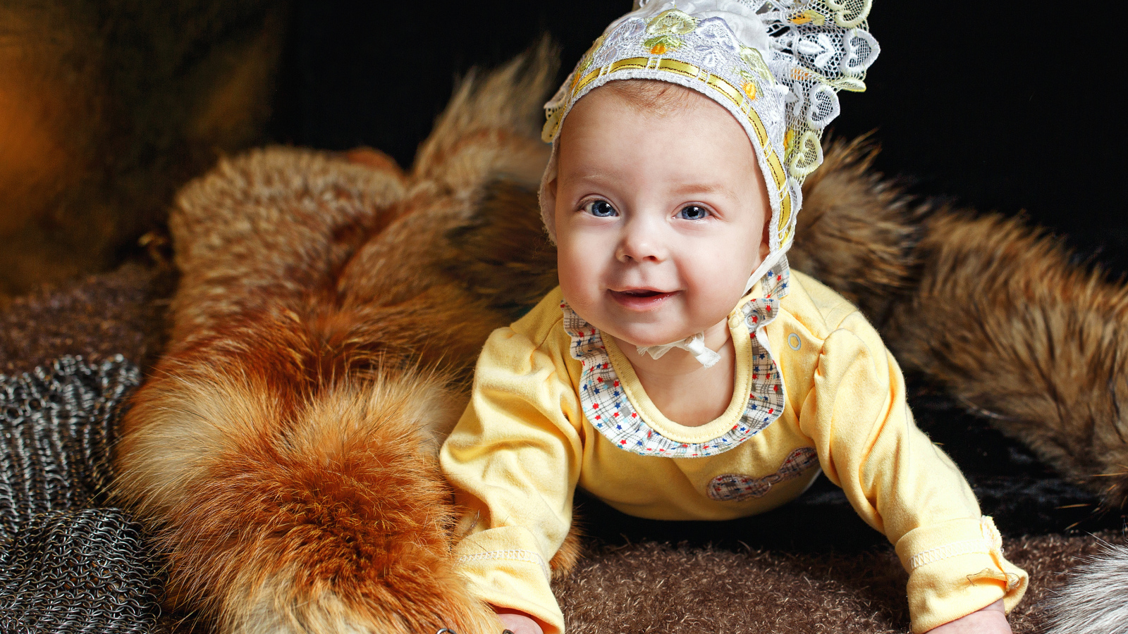 Улыбающаяся голубоглазая девочка в шапке