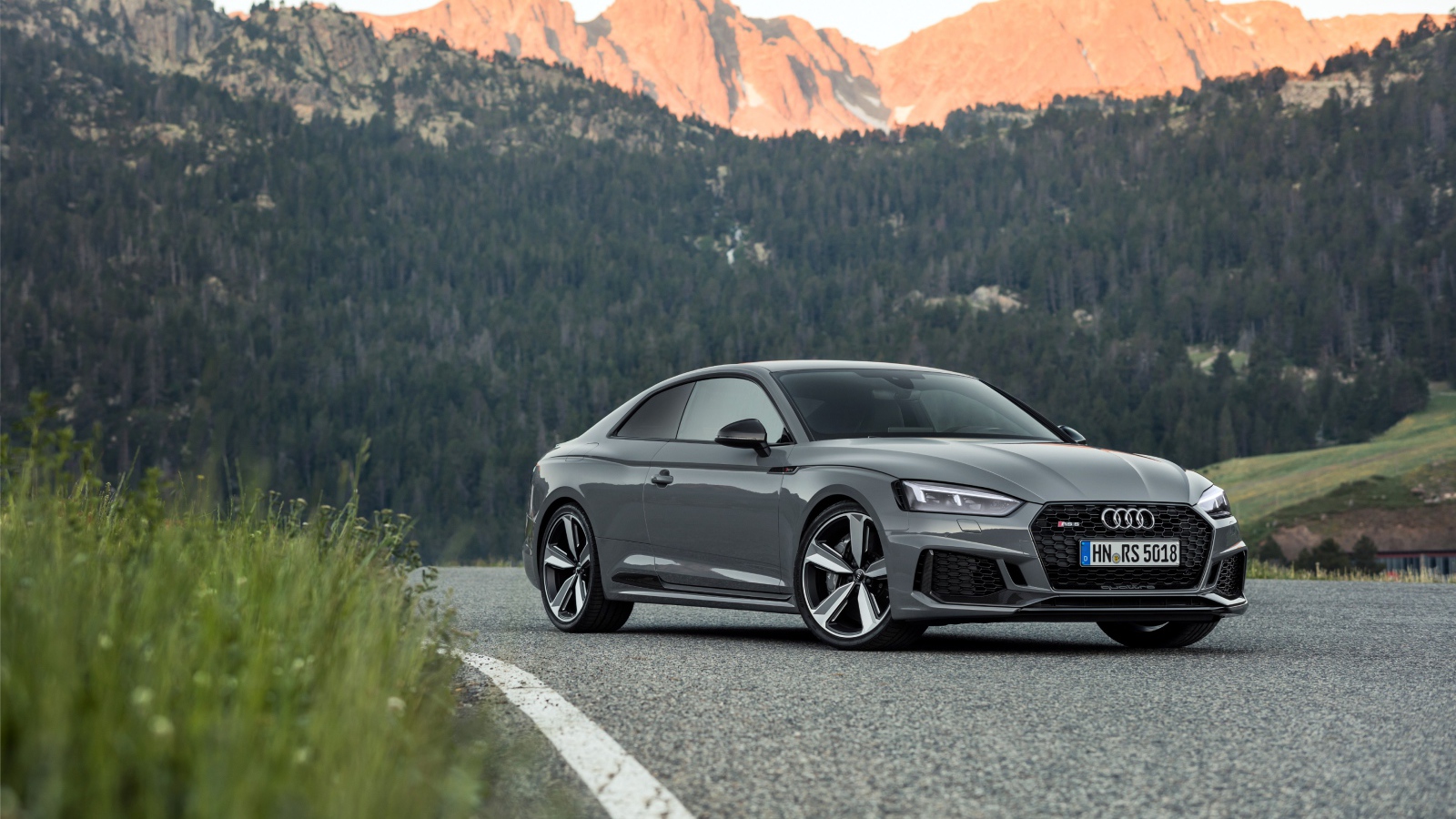 Silver car Audi RS5 2018 on the background of the mountains