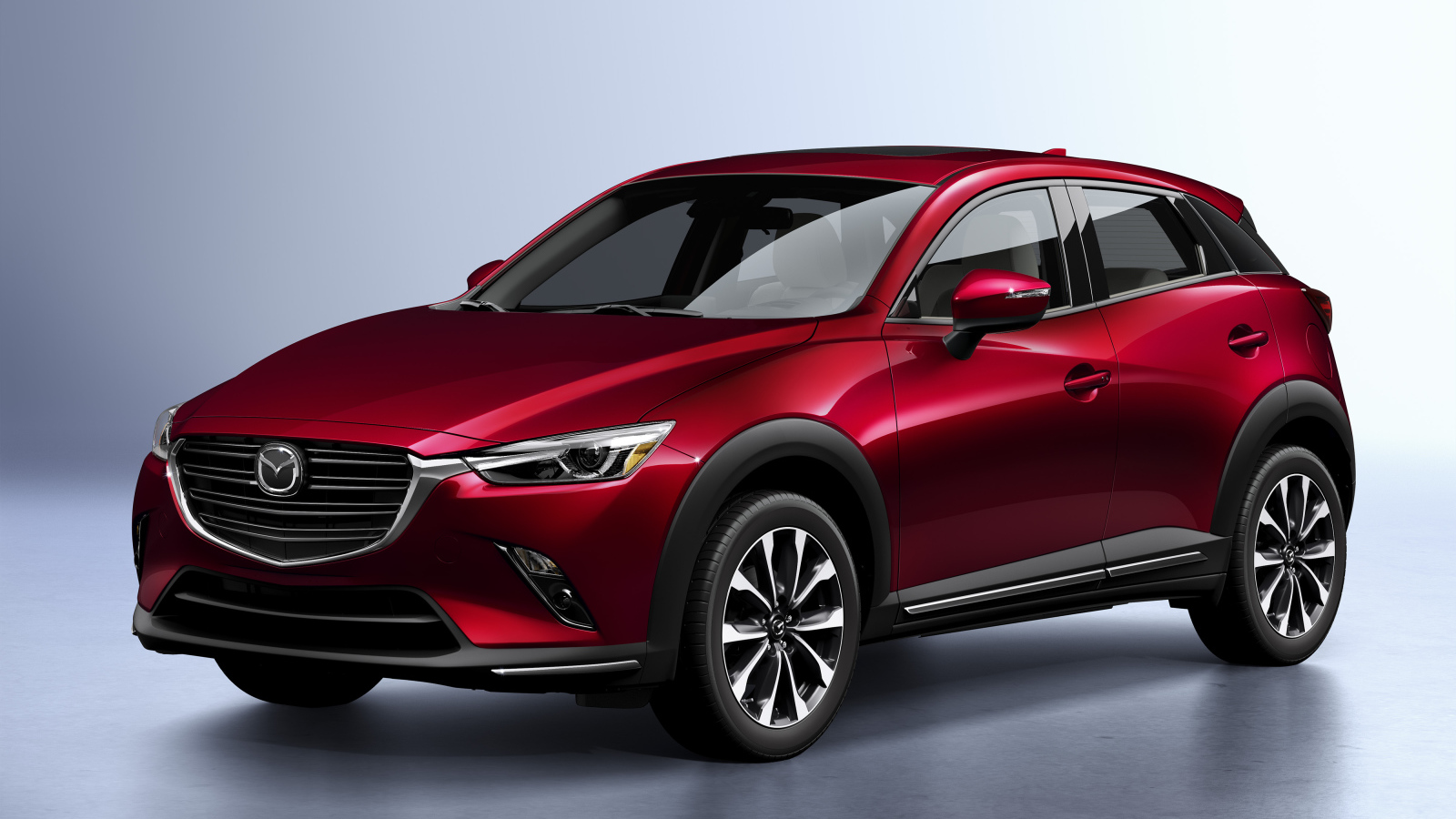 Бордовый внедорожник Mazda CX-3, 2019 года на сером фоне