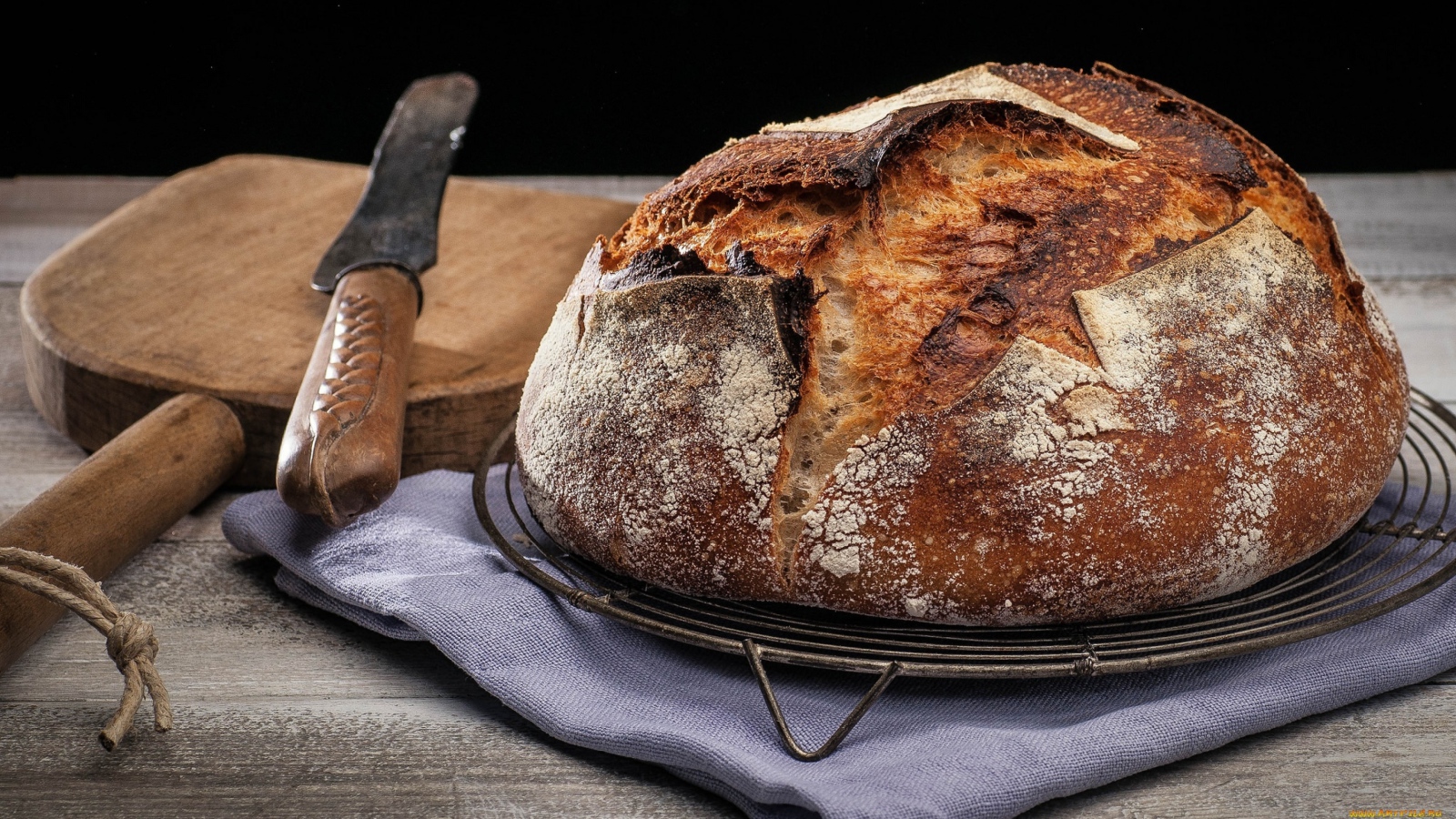 Зажареный круглый хлеб на столе с ножом