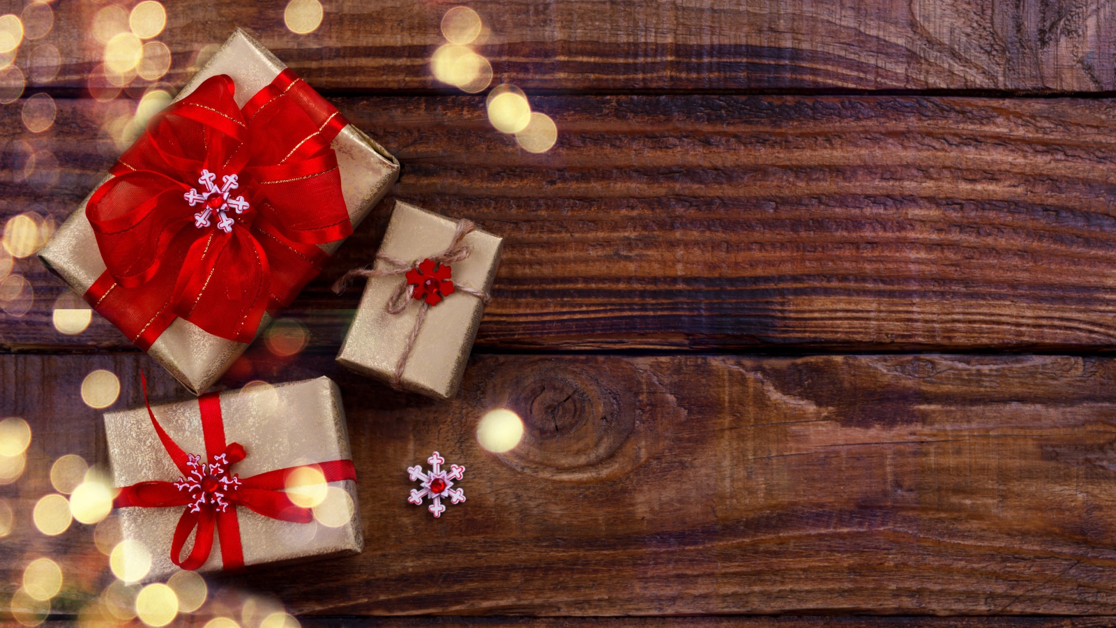 Holiday gifts on wooden background