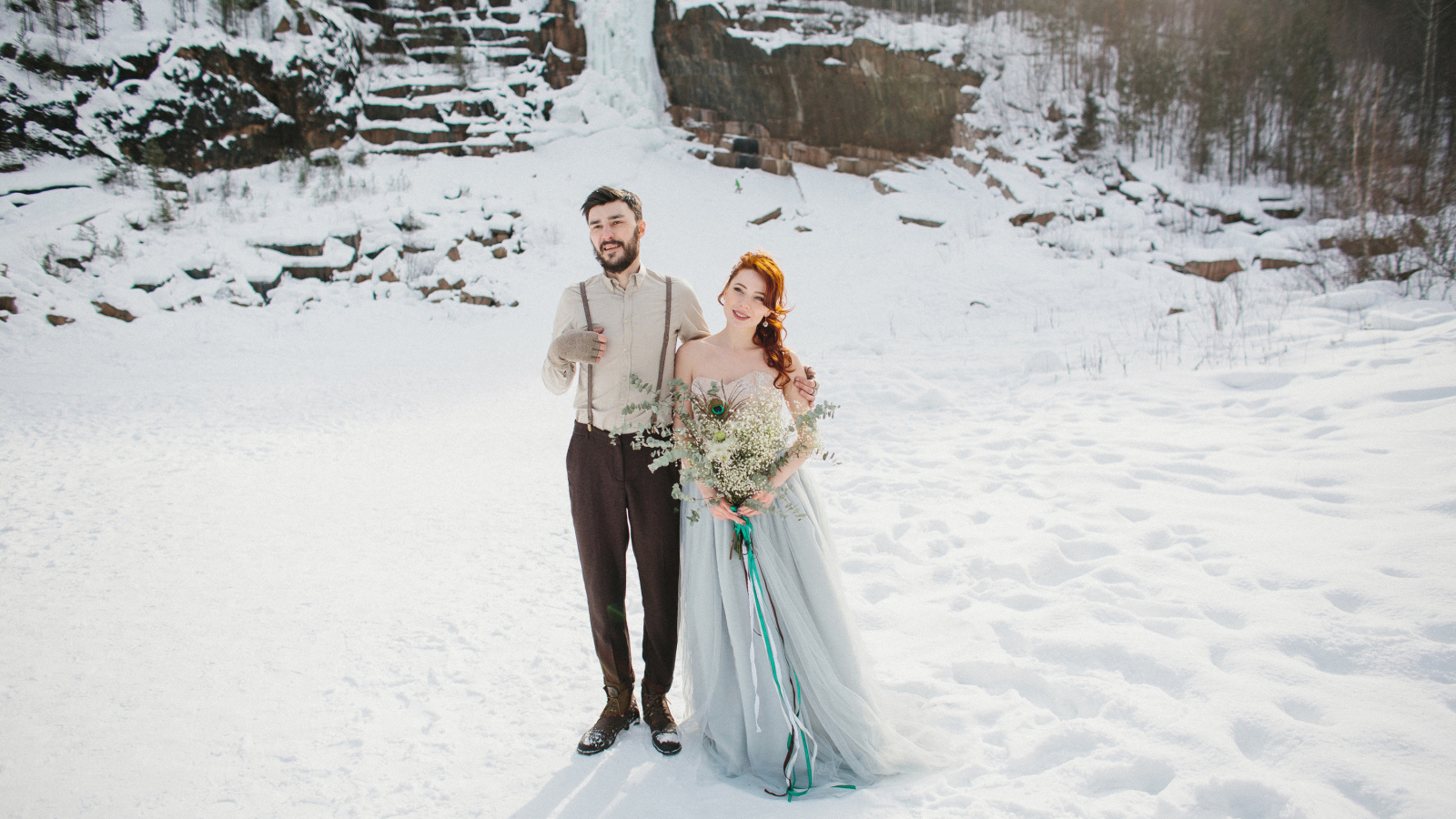 Влюбленная пара молодоженов стоит на снегу