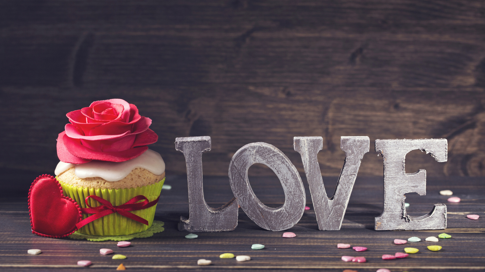 Inscription Love with a beautiful cupcake with a red heart