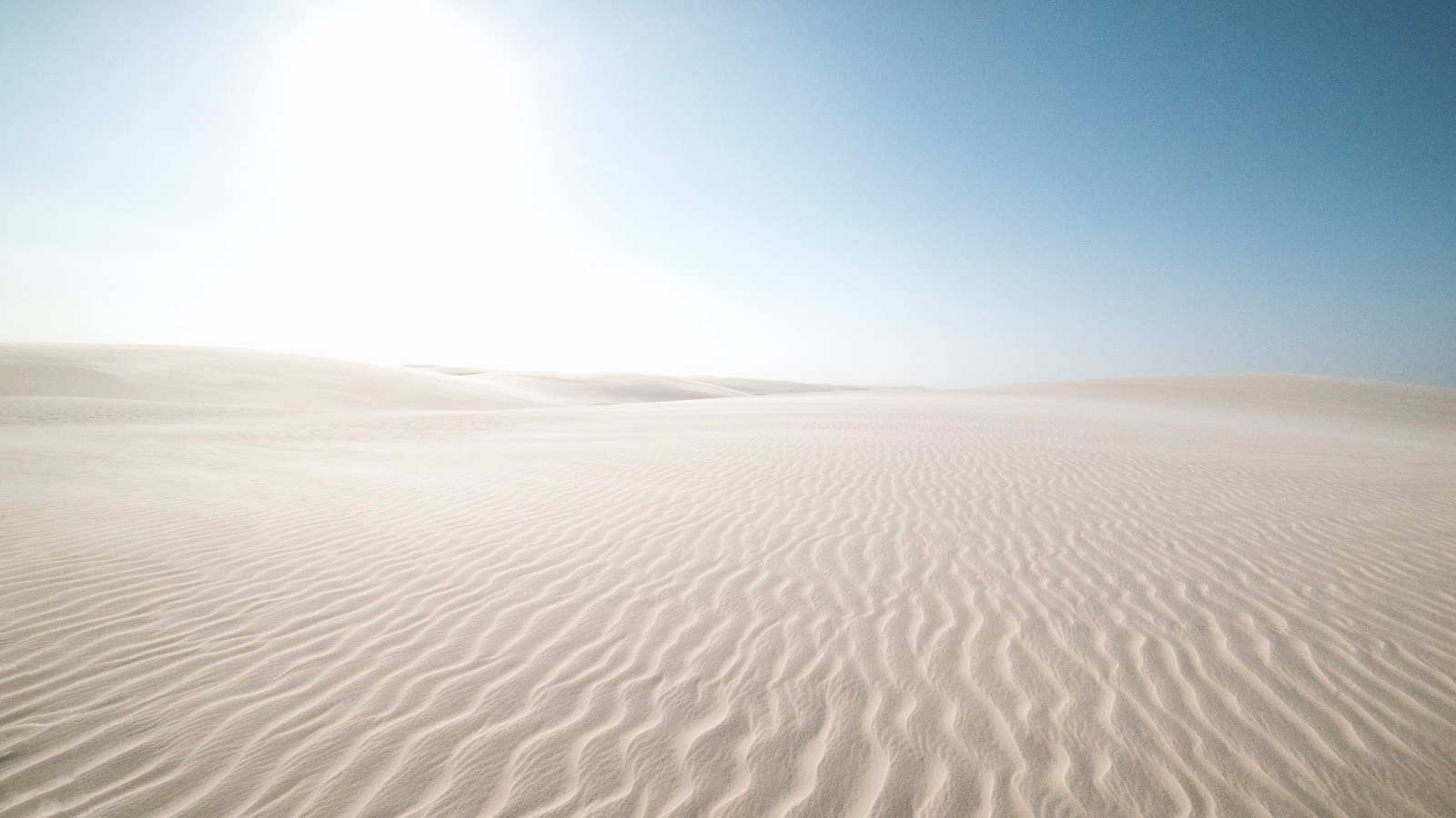 Белый песок в пустыне на фоне голубого неба
