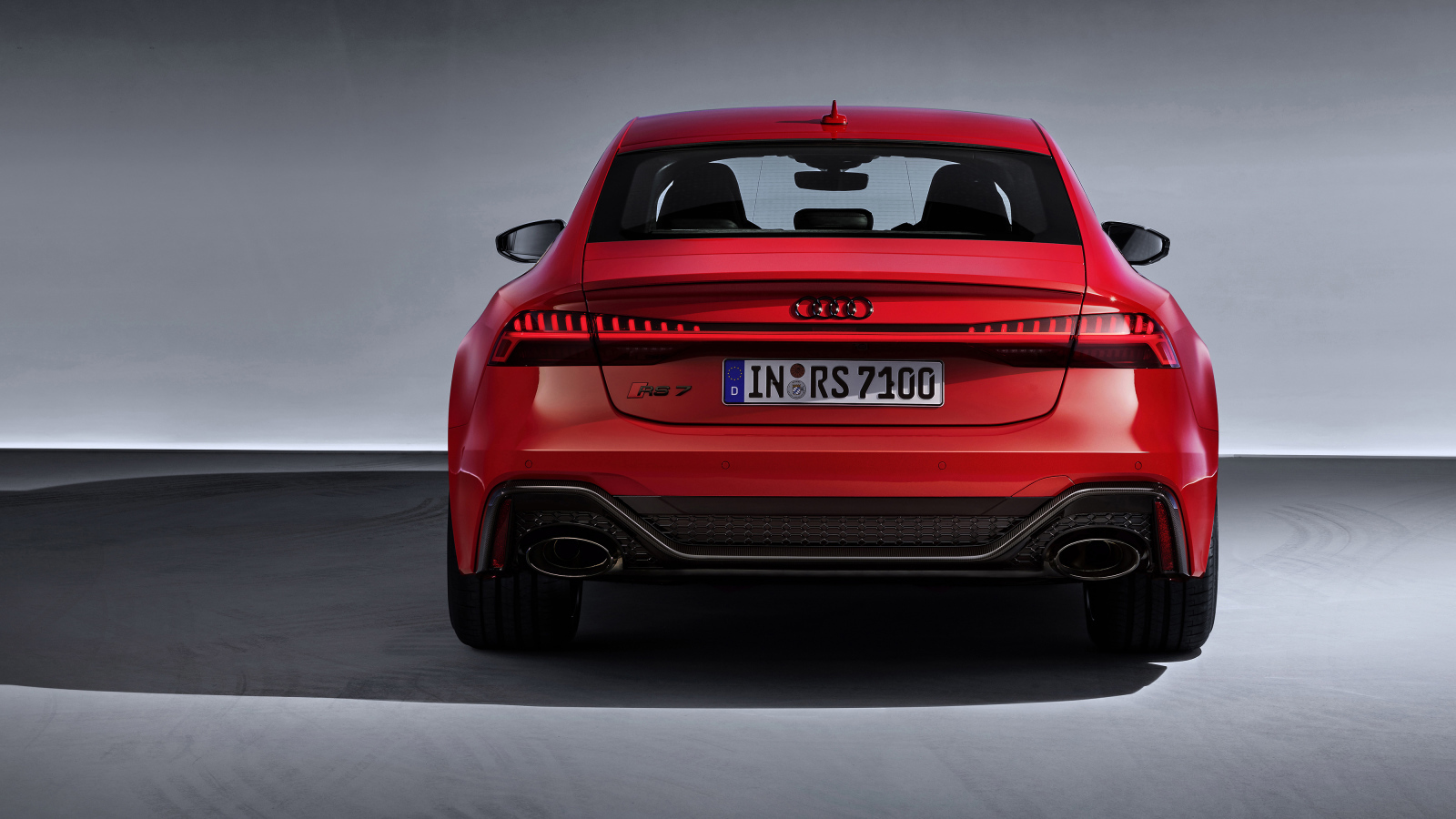 Red 2019 Audi RS 7 Sportback car on a gray background rear view