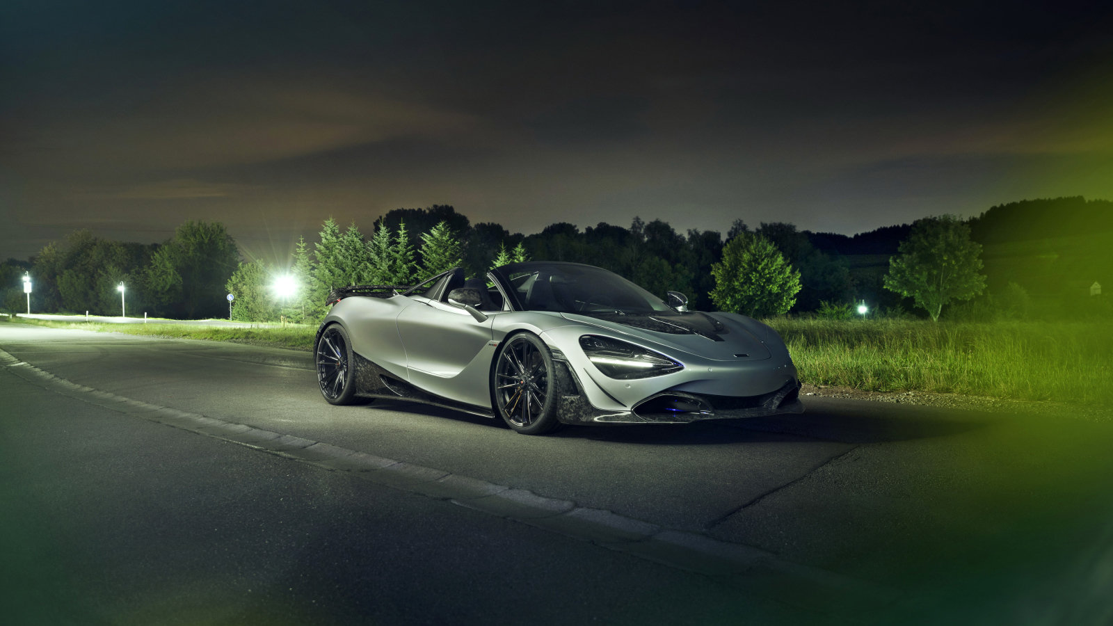 Серебристый автомобиль McLaren 720S Spider 2019 года ночью на дороге