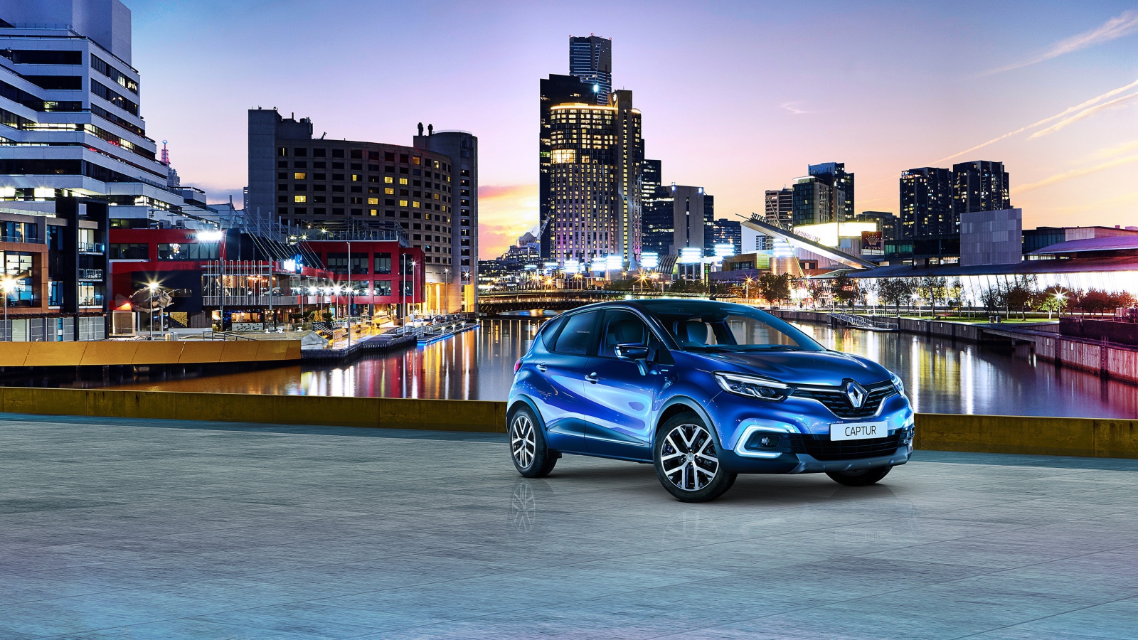 Stylish blue car Renault Captur on the background of the city