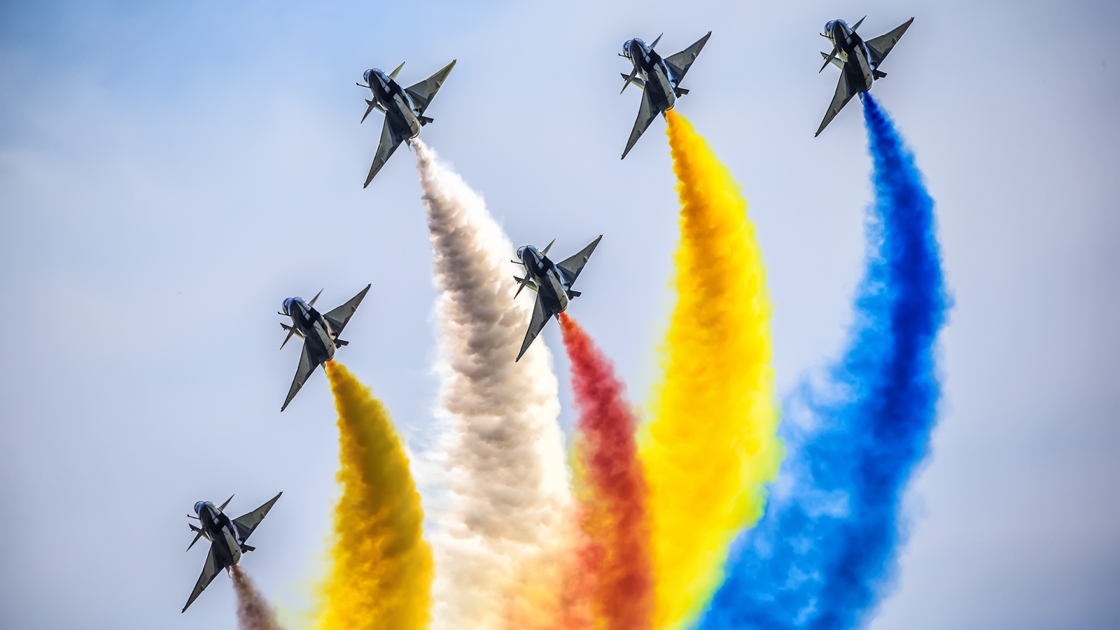 Fighters with colorful smoke in the sky