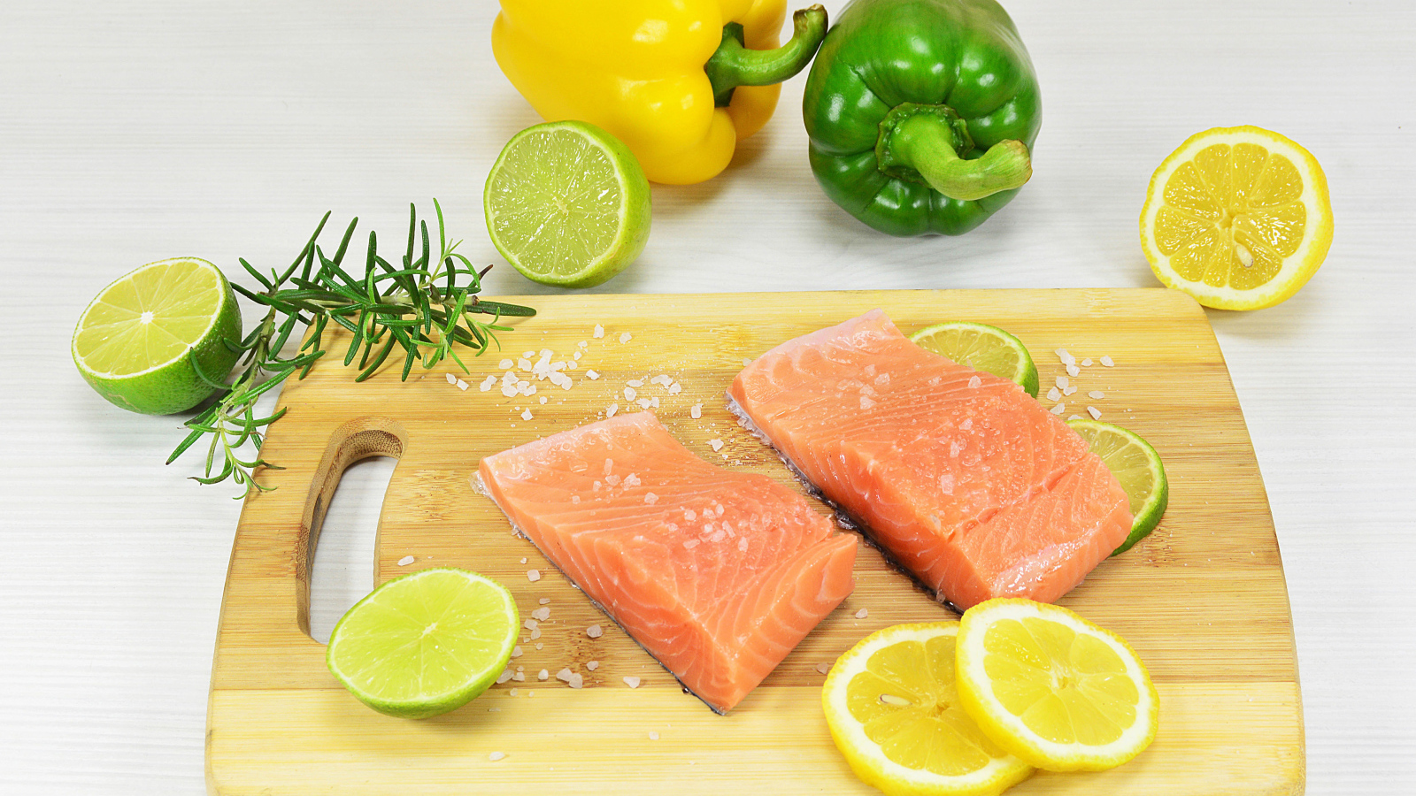 Красная рыба на разделочной доске с лимоном и перцем 