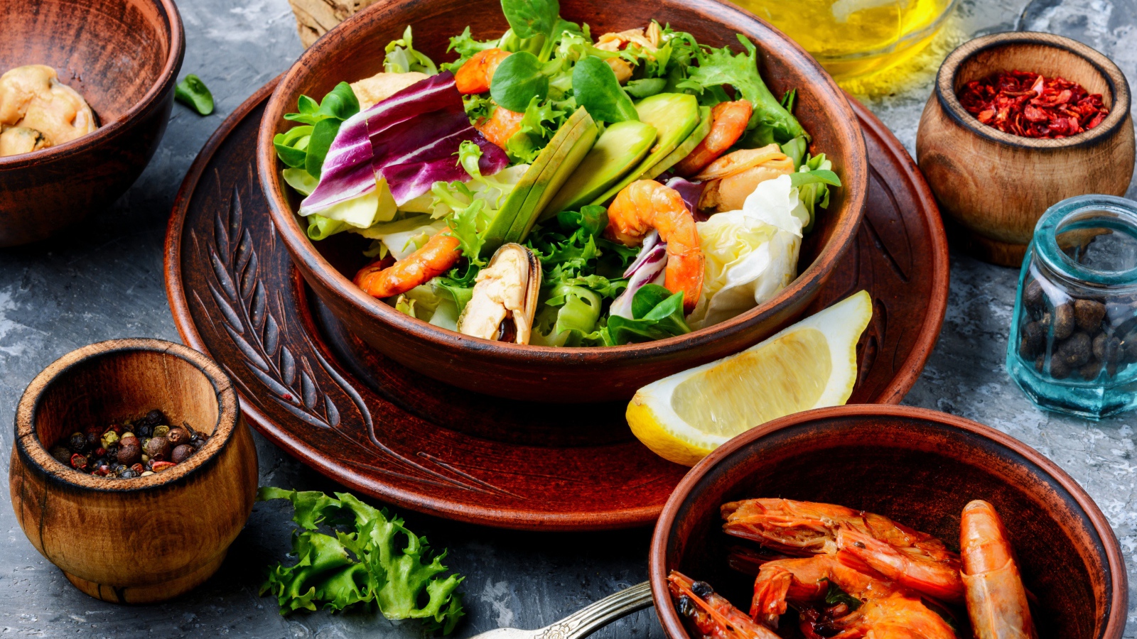 Salad with seafood is on the table with spices