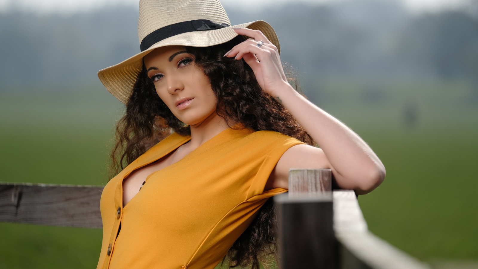 Длинноволосая шатенка в большой шляпе 