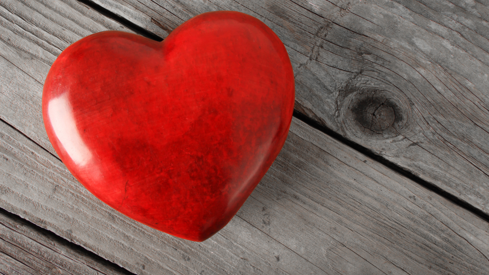Большое красное сердце на деревянном столе