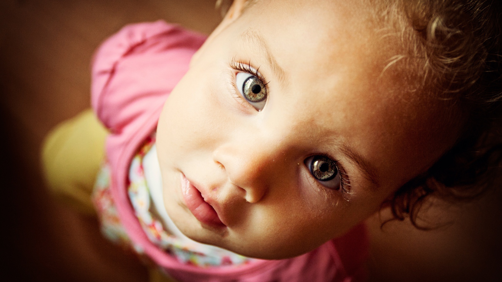 Маленькая девочка крупным планом смотрит вверх 