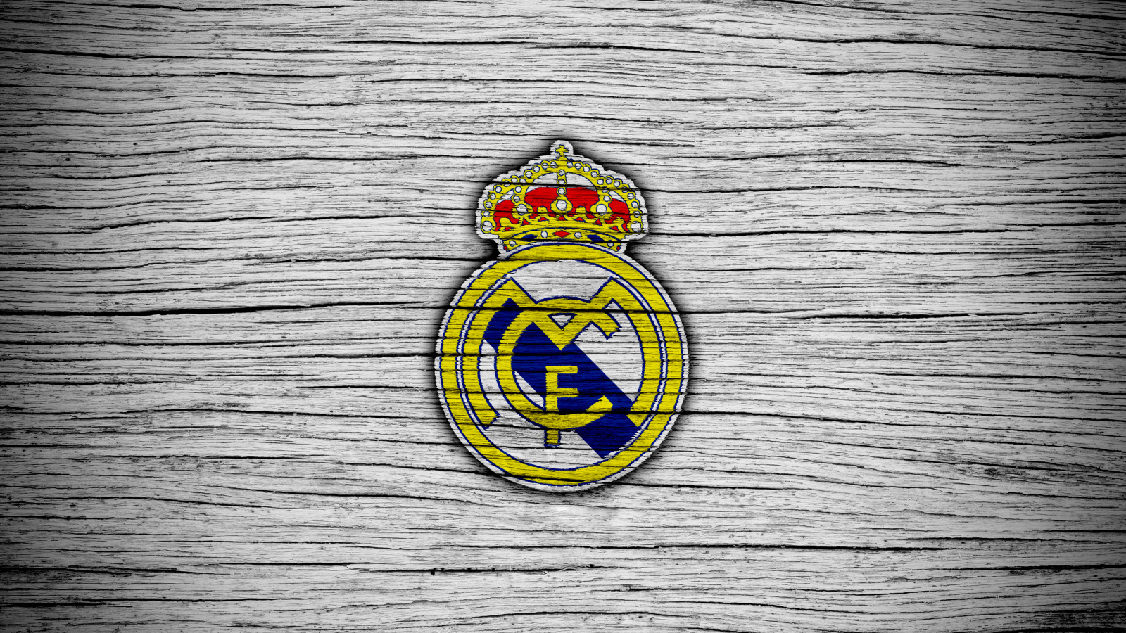 Логотип футбольного клуба Реал Мадрид на сером фоне