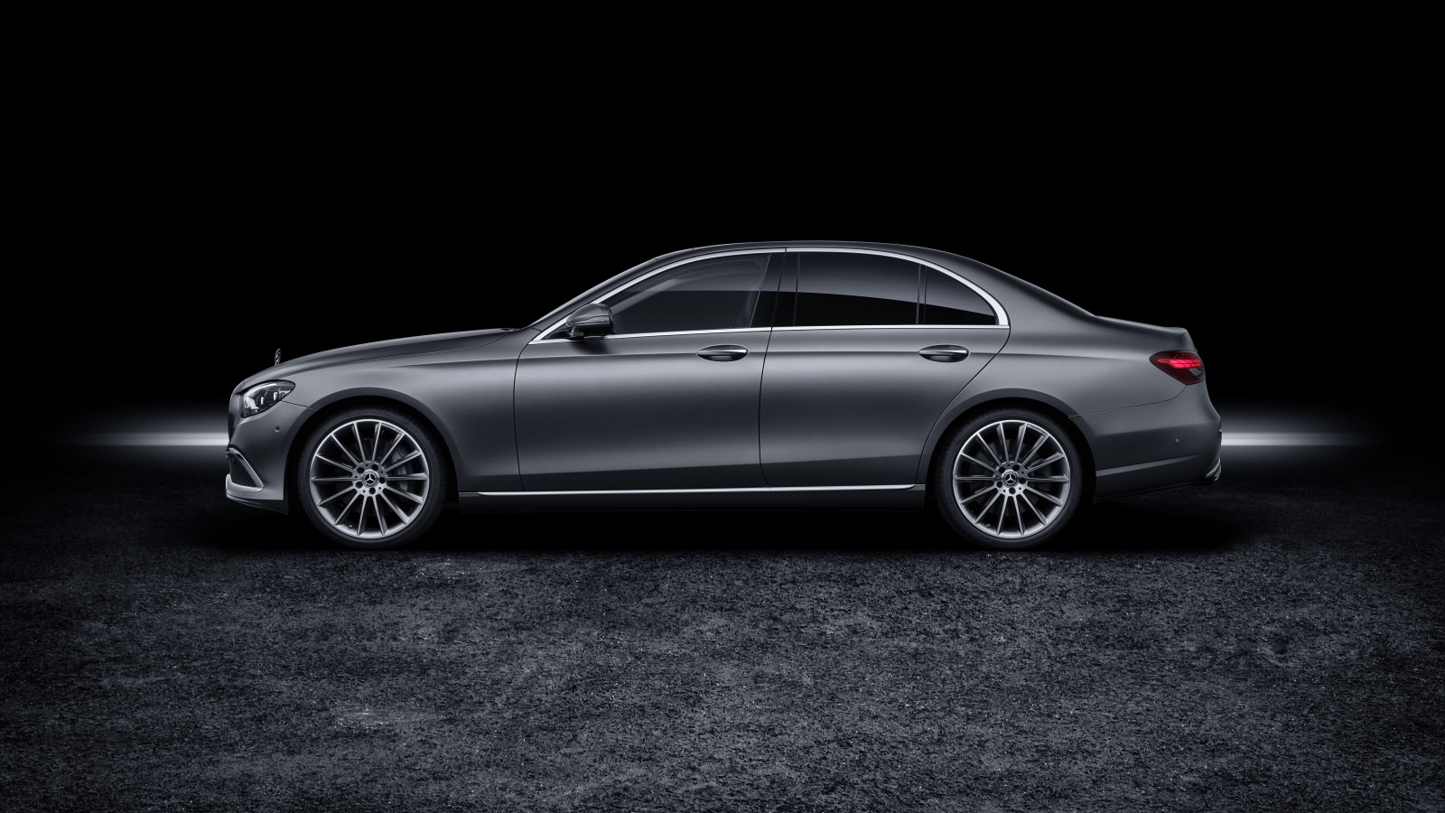 Серебристый автомобиль Mercedes-Benz E-Klasse 2020 года на черном фоне