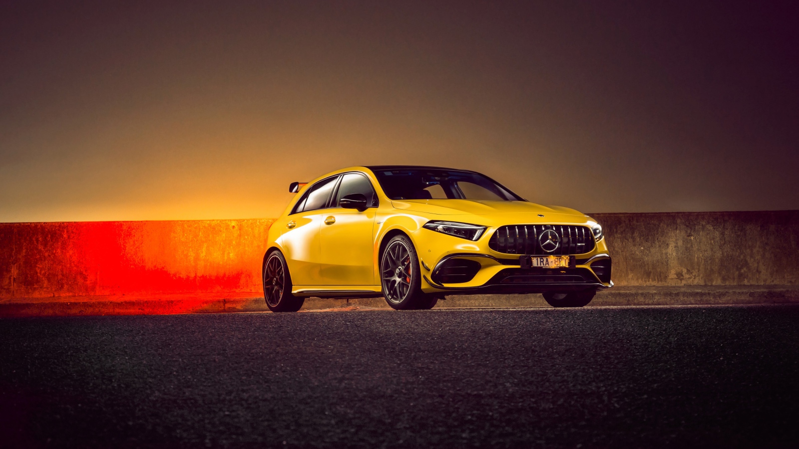 Желтый автомобиль Mercedes-AMG A 45 S,  2020 года на асфальте 