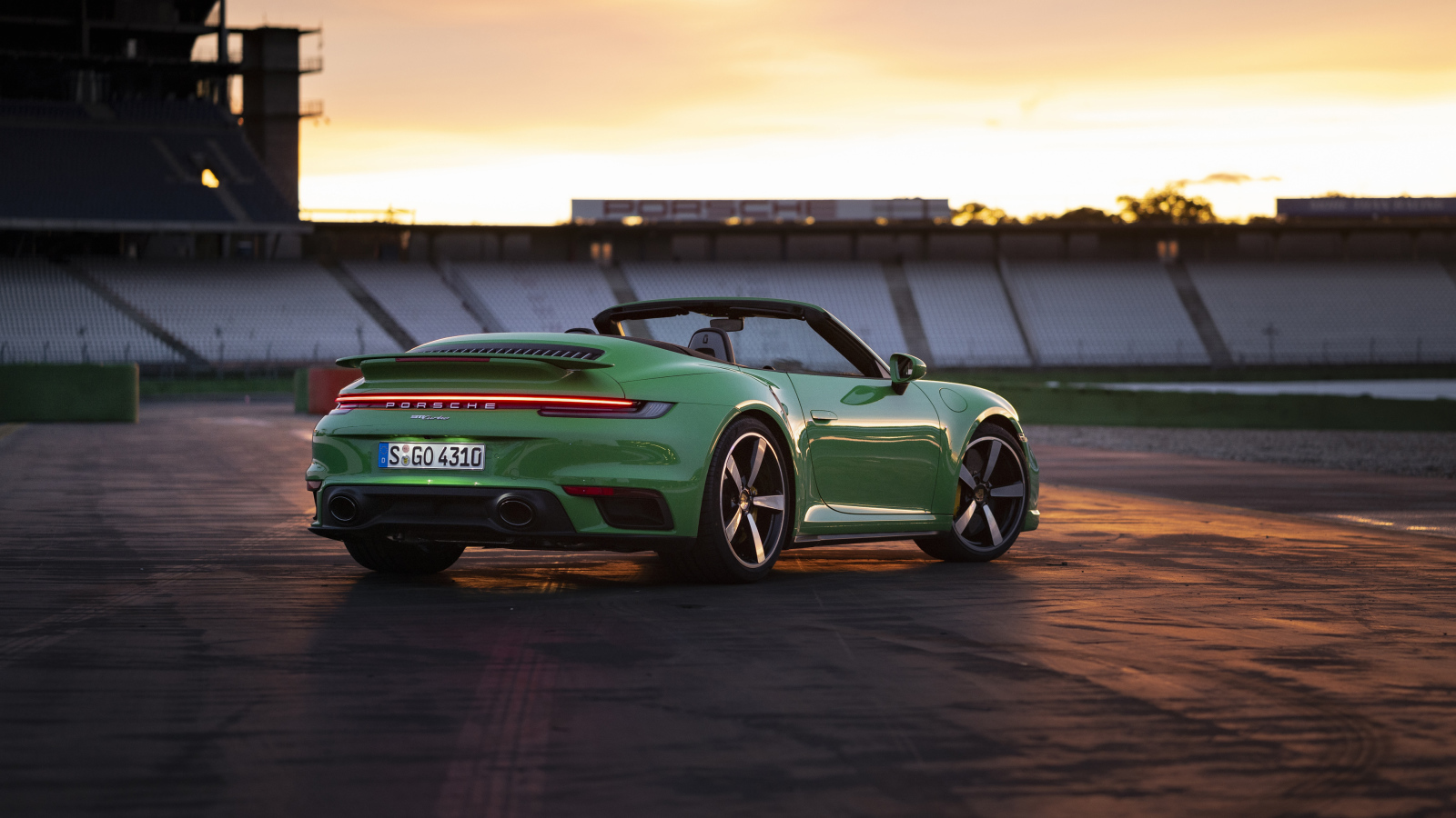 Зеленый автомобиль Porsche 911 Turbo Cabriolet 2020 года вид сзади