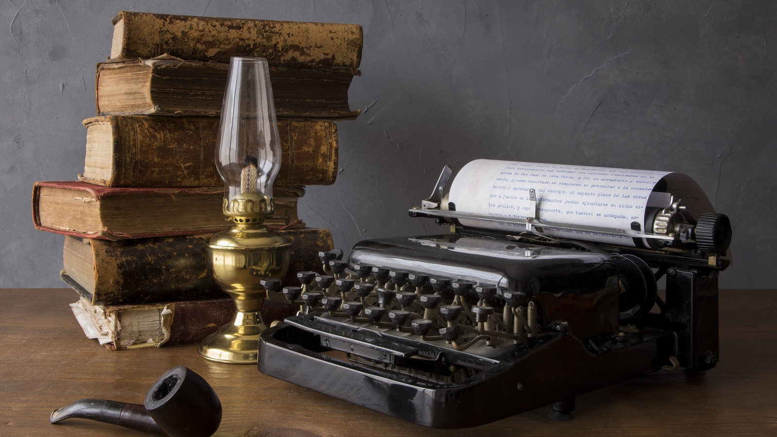 Old typewriter, books, kerosene lamp and tube on the table