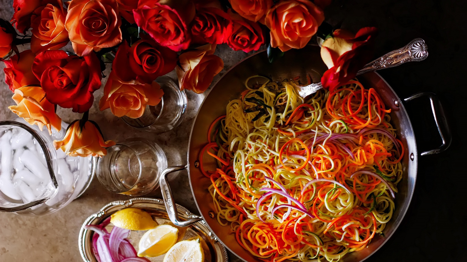 Салат из овощей на столе с розами 