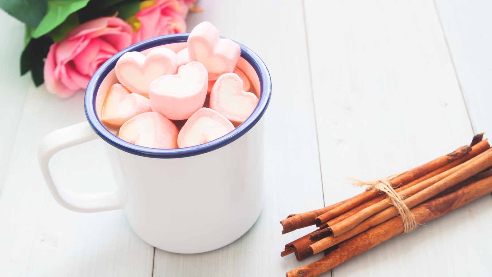 Железная чашка какао с маршмеллоу на столе с корицей 