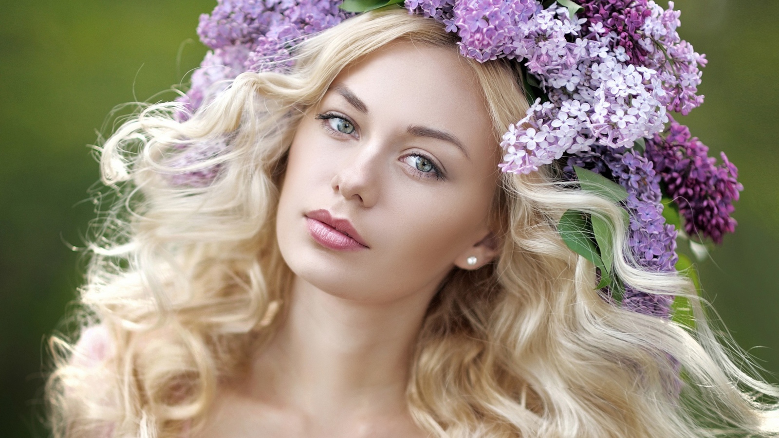 Beautiful blonde with a wreath of lilac in her hair