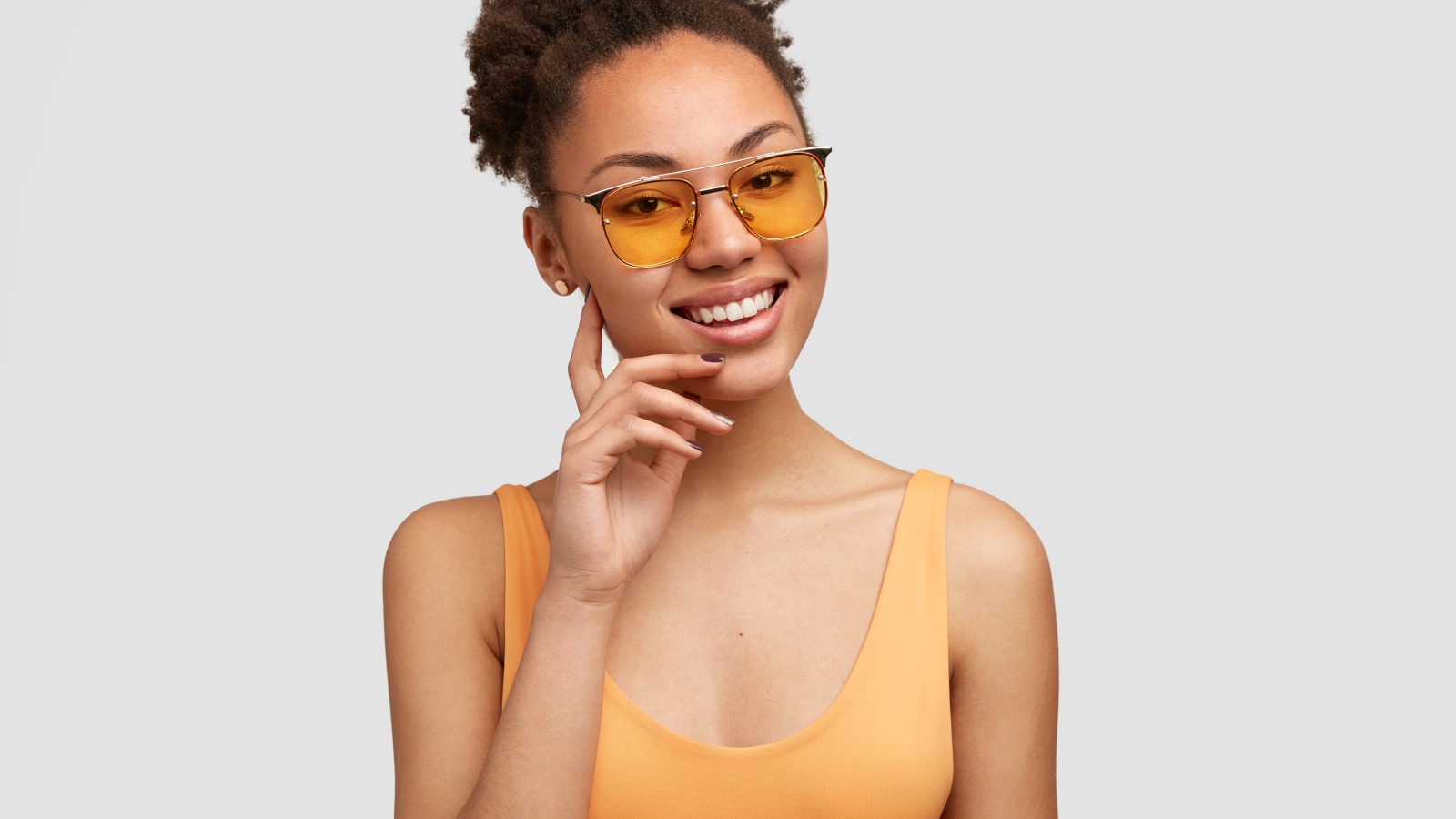 Красивая улыбающаяся темнокожая девушка в солнечных очках