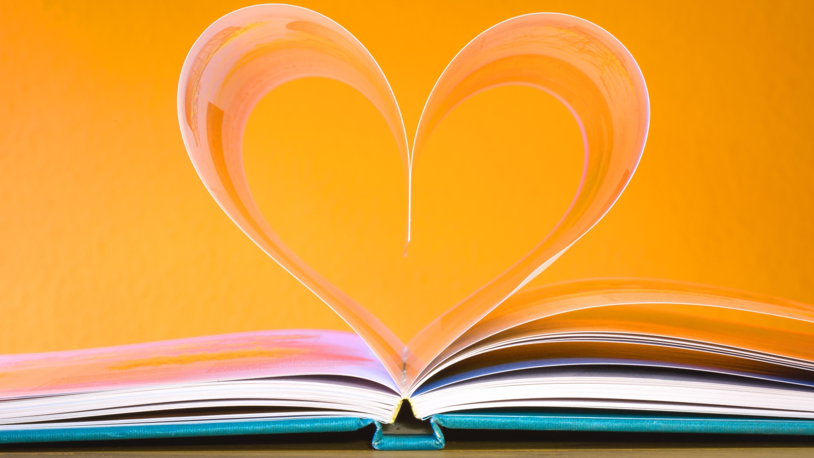 Heart from book pages on a yellow background