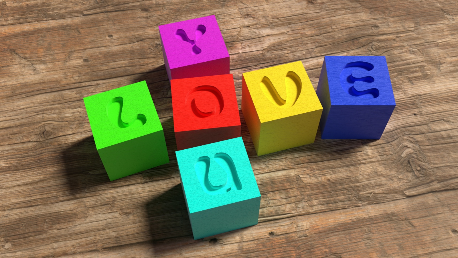 Разноцветные кубики с надписью Love  на деревянном столе 