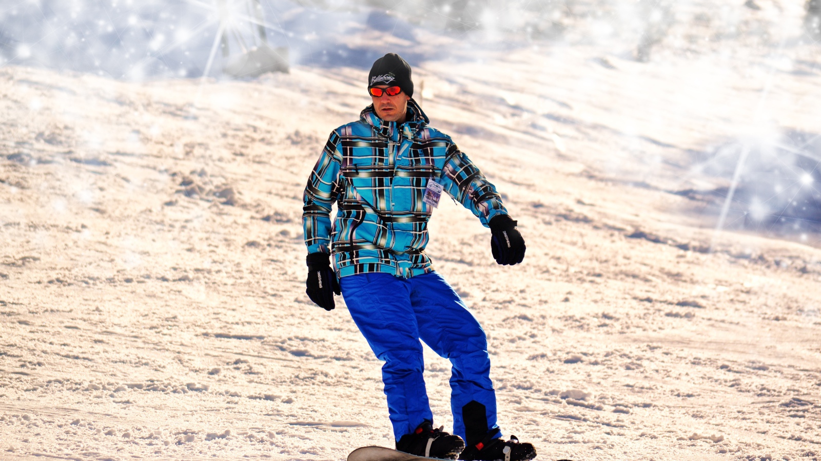 A man snowboarder drives down the mountain