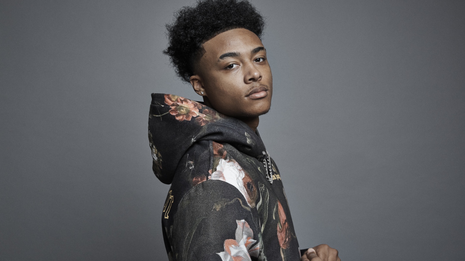 Рэпер Luh Kel на сером фоне