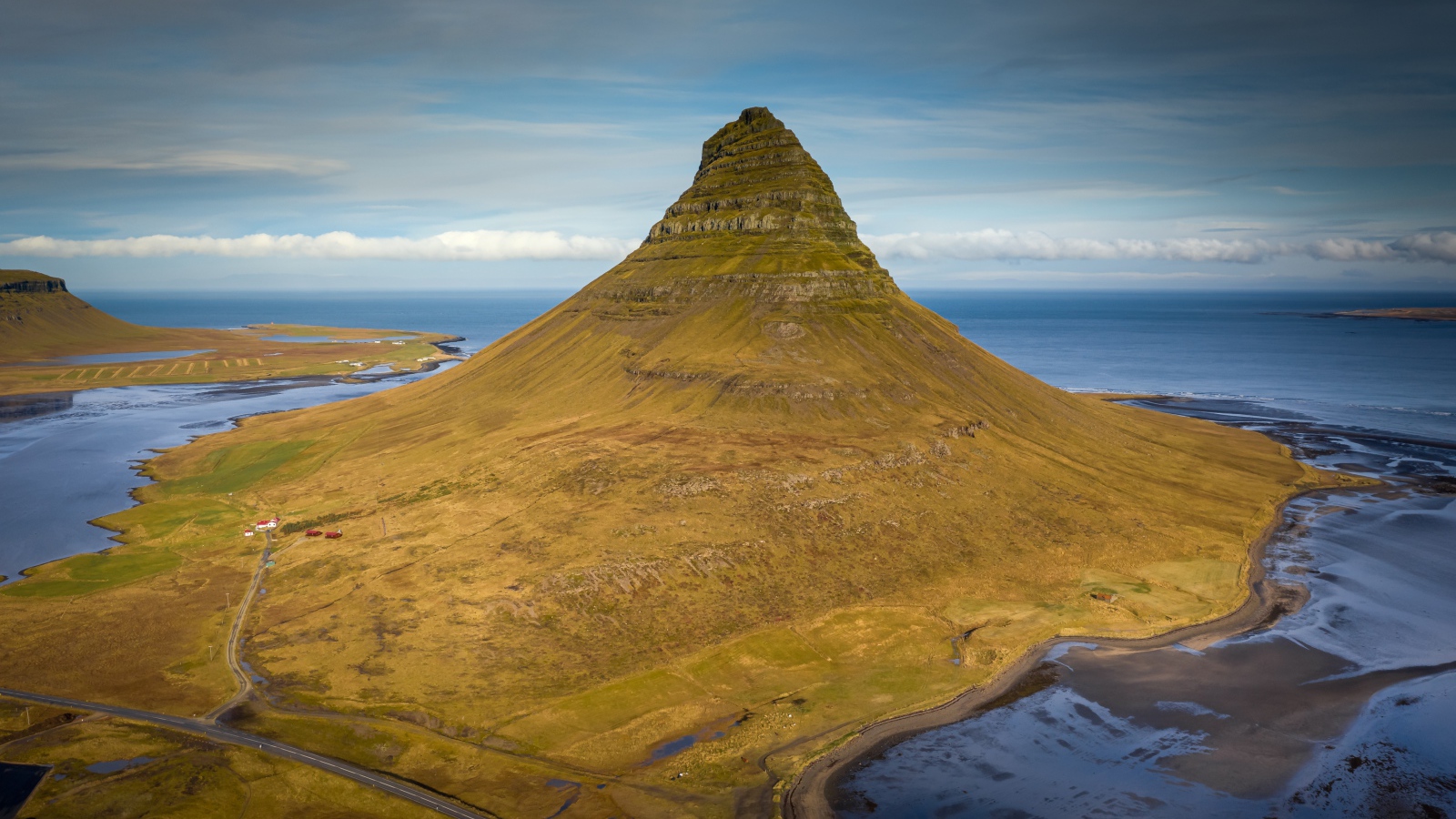 Зеленая гора Киркьюфетль под голубым небом, Исландия